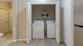 A washer and dryer in a laundry room with doors open